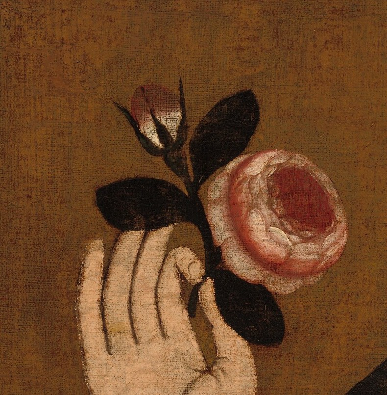 Held delicately, the rose is a classic symbol of love, beauty, and perhaps transience.