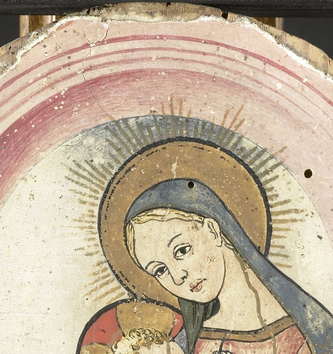 Painted with a warm gold, the halo's crisp outline contrasts against the arched architectural background, marking sanctity.