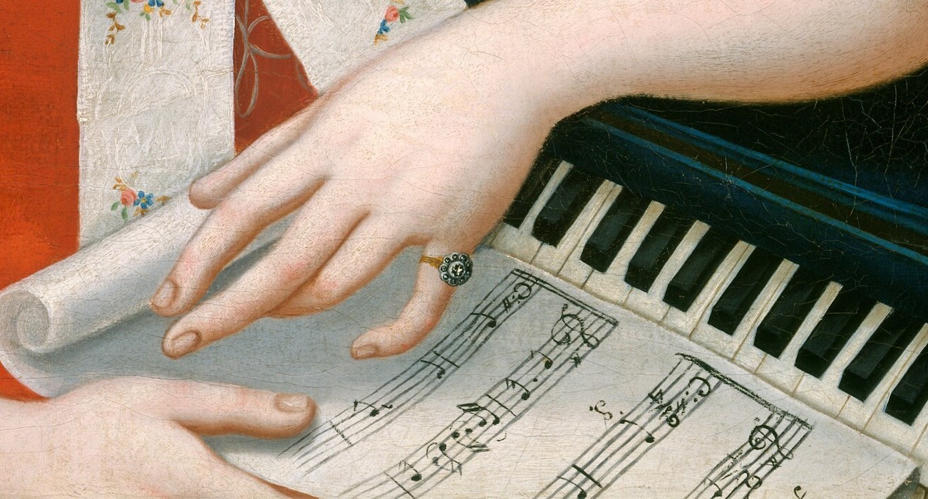 Her hands are poised, as if she is about to play.