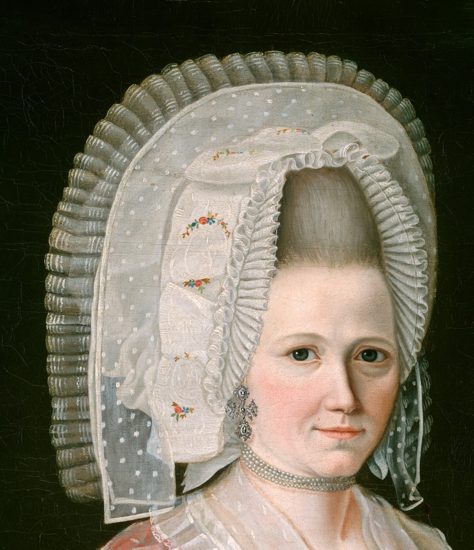 The voluminous, layered cap with its sheer veil is a striking fashion statement of the era, emphasizing social status.