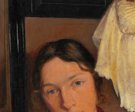 A dark portrait hangs in the background.