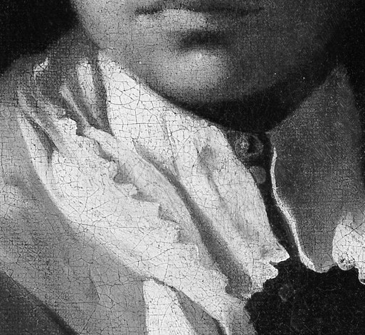 The stark white of the collar contrasts sharply with his dark clothing, highlighting his face and neck.