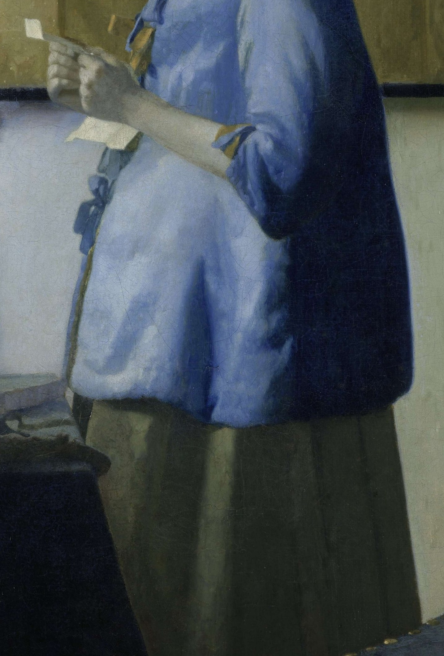 The luminous blue fabric, a signature Vermeer color, is rendered with exquisite detail, highlighting the texture and folds.