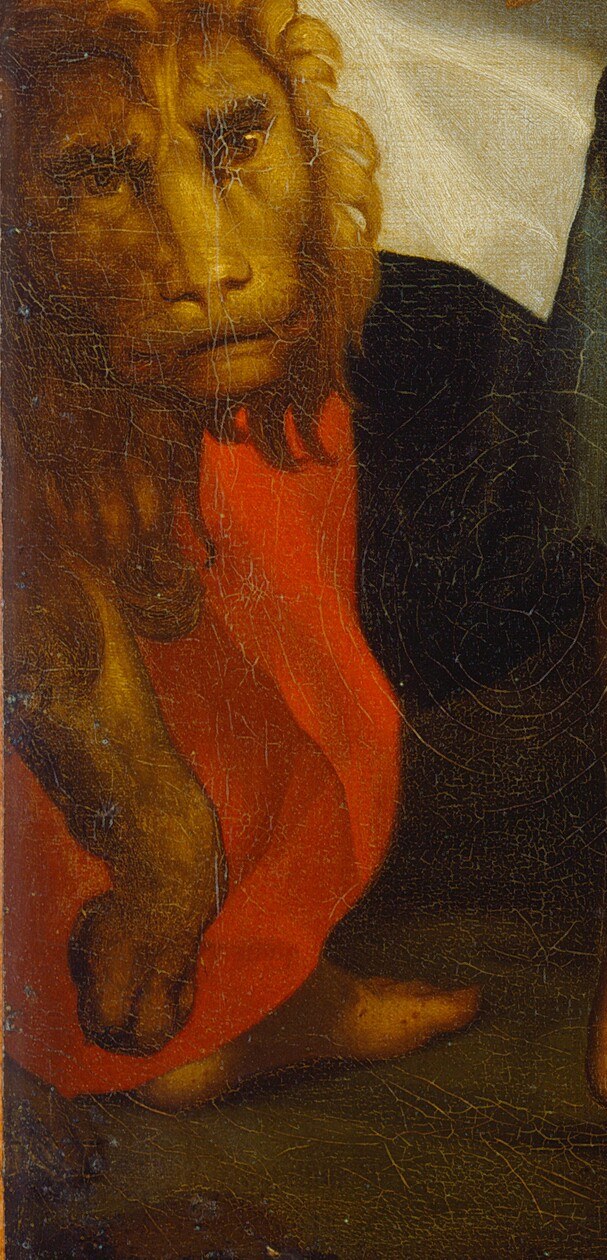 Yet a small detail identifies him, tucked away.