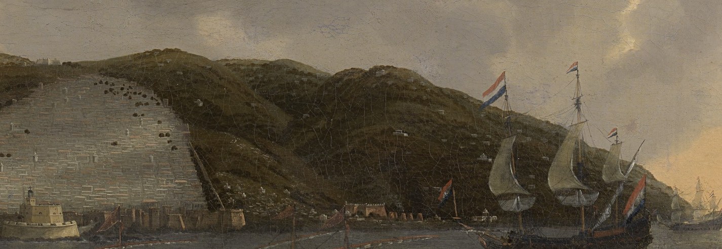 The city climbs white up the hillside to the mountains.