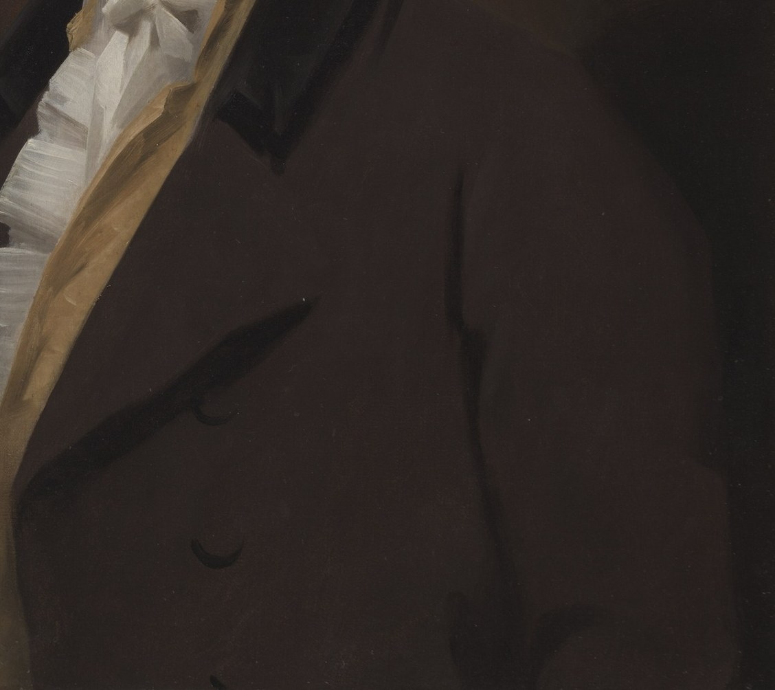 Hope wears a dark coat and gold sash.