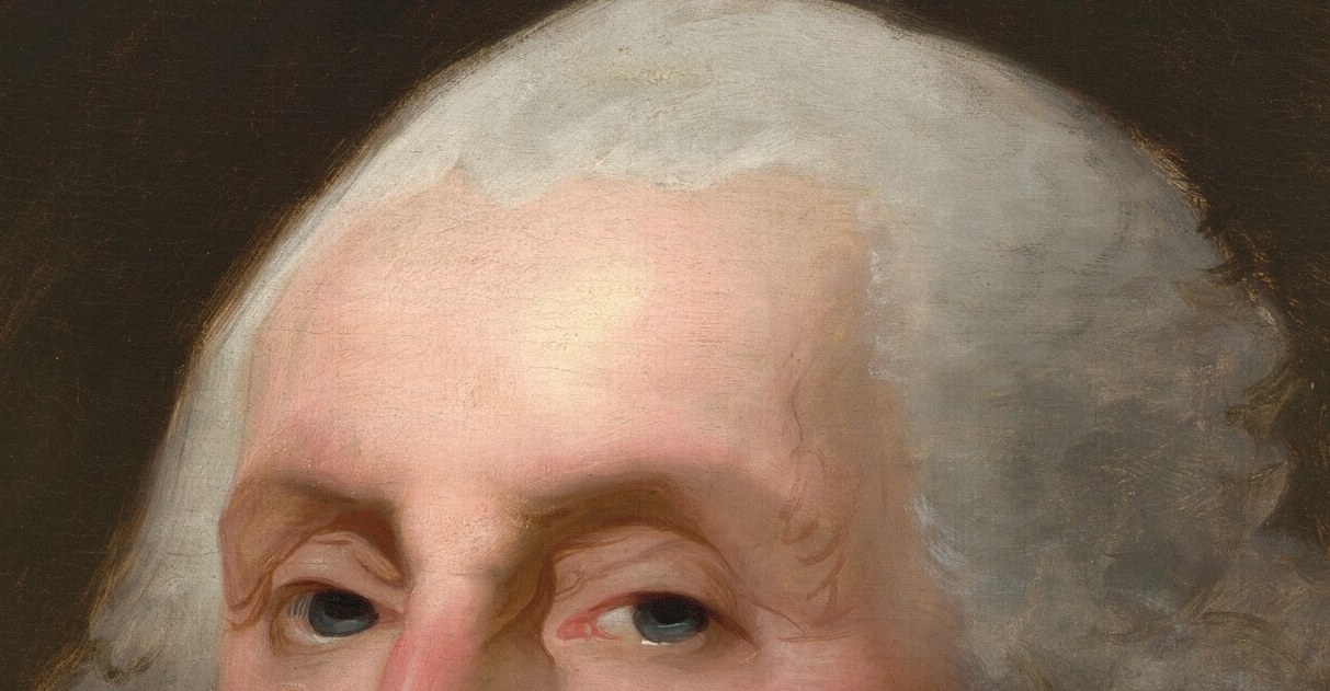 His eyes, steady and distant, convey the burden of command.