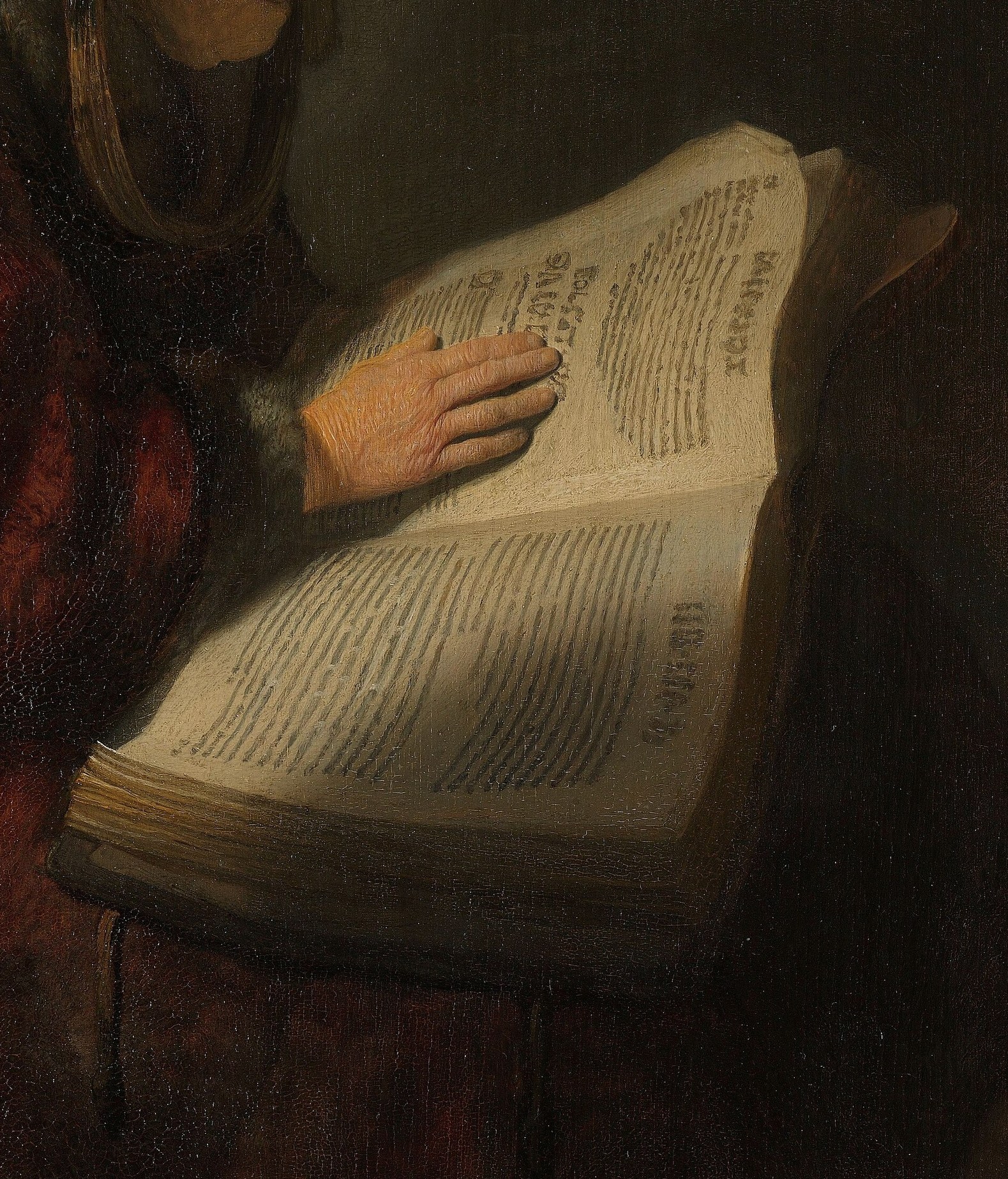 This woman is absorbed in her book, illuminated by a strong light.