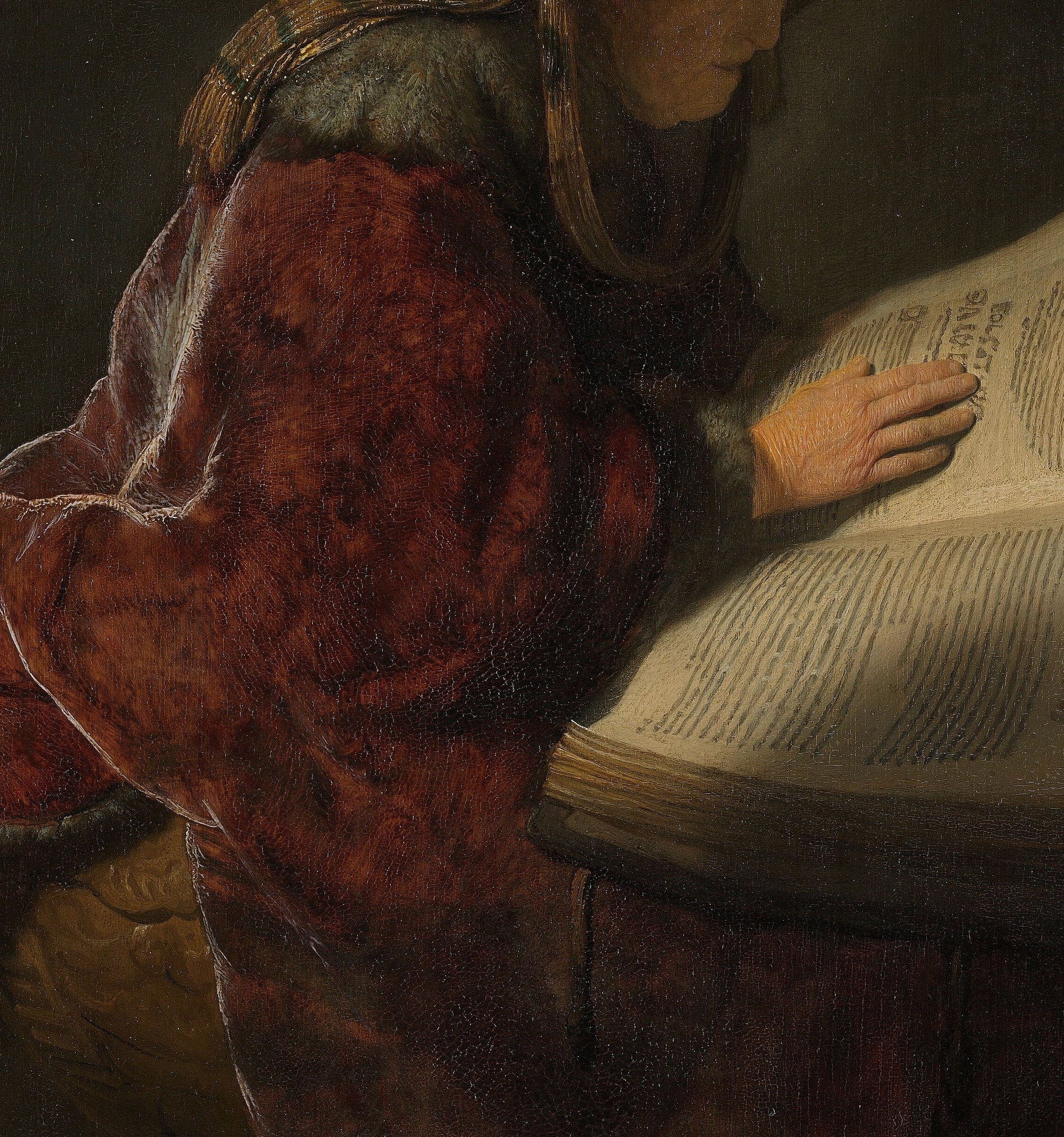 The rich texture and deep folds of the fabric create a sense of warmth and gravitas, contrasting with the illuminated book.