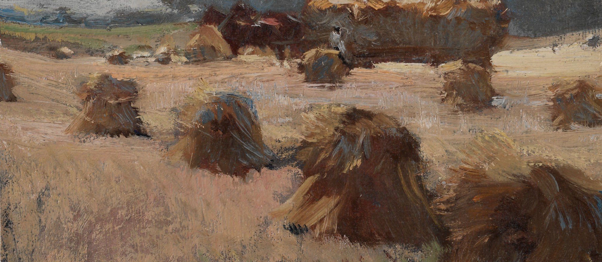 The horses strain against their heavy load, on muddy ground.