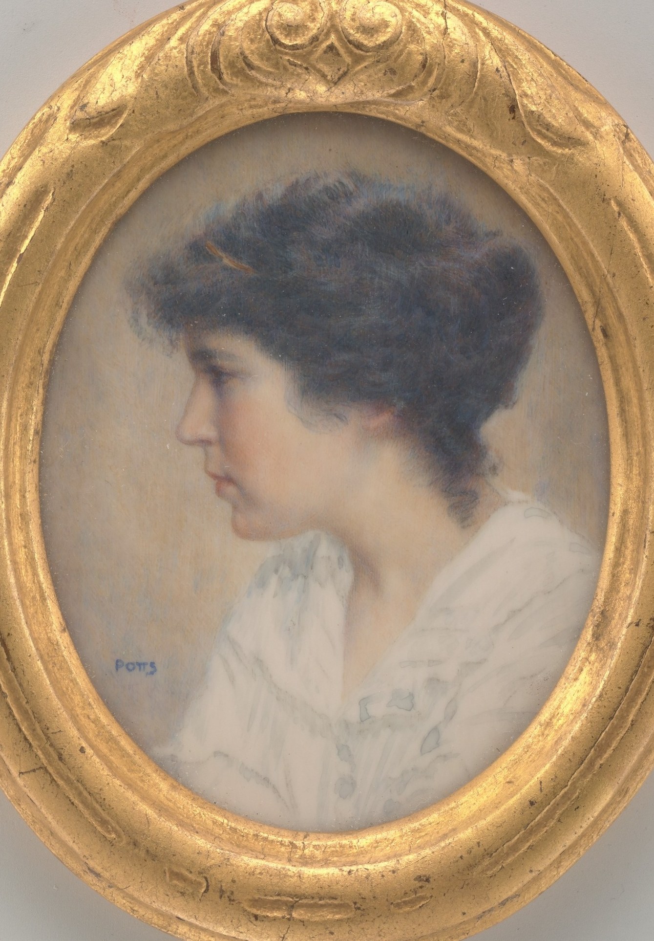 The heavy gilt oval frame is an integral part of the portrait's visual identity , oval formats for profile portraits echo cameo and medallion traditions