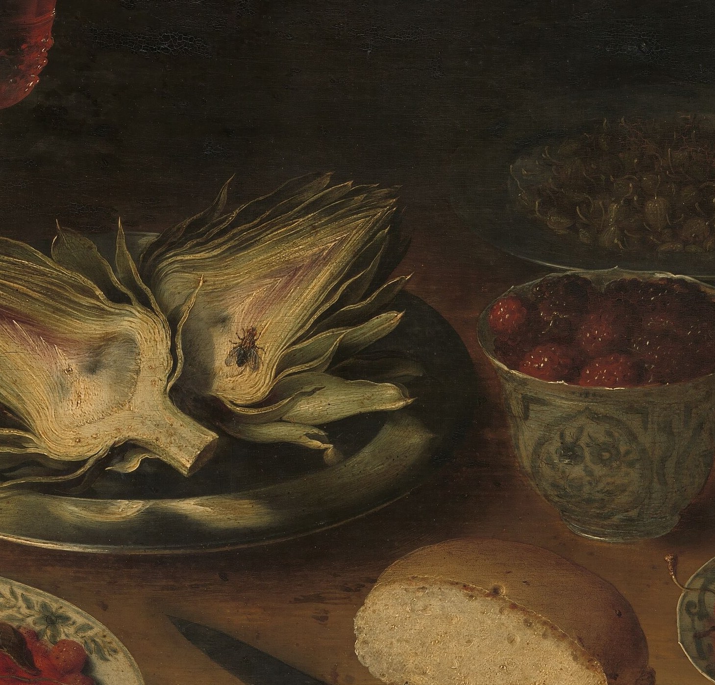 The splayed artichoke leaves create an architectural focal point; artichokes were luxury vegetables in early 17th-century Northern Europe, signaling refined taste.