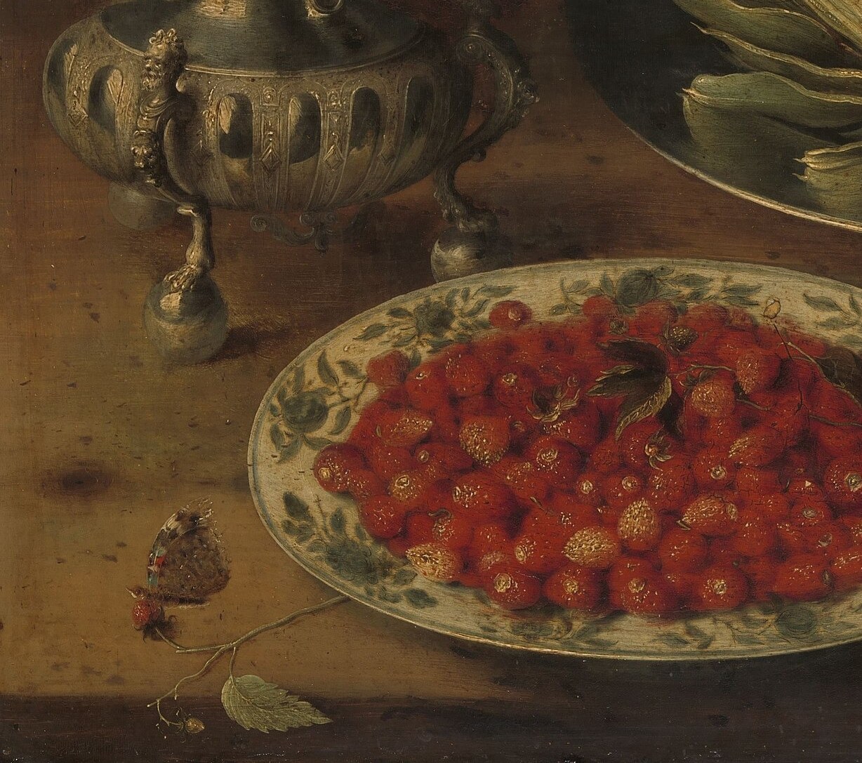 The lustrous white porcelain contrasts sharply with the vivid red berries; a prime example of the Dutch East India trade bringing exotic wares to European tables.