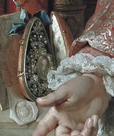 The open case, possibly a snuff box, hints at personal interests.