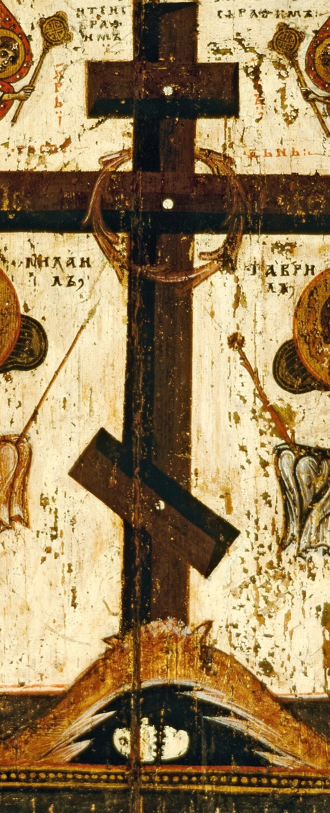 The central cross is the focus, dark and weathered.