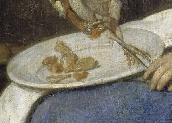 She prepares fowl on a plate.