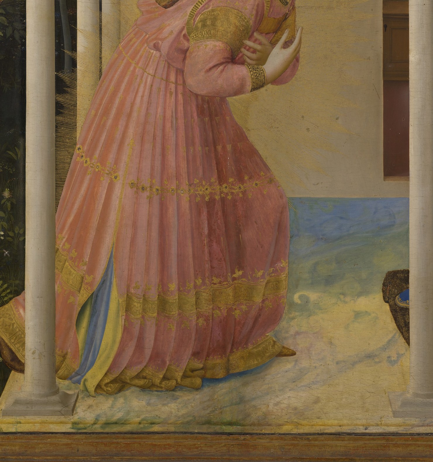 He wears a pink robe, symbolizing grace.