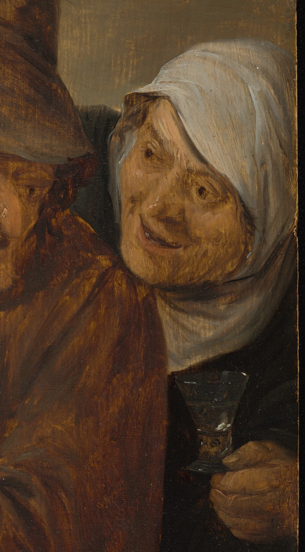 Her raised glass and shared glance with the man indicate conviviality and perhaps a toast.