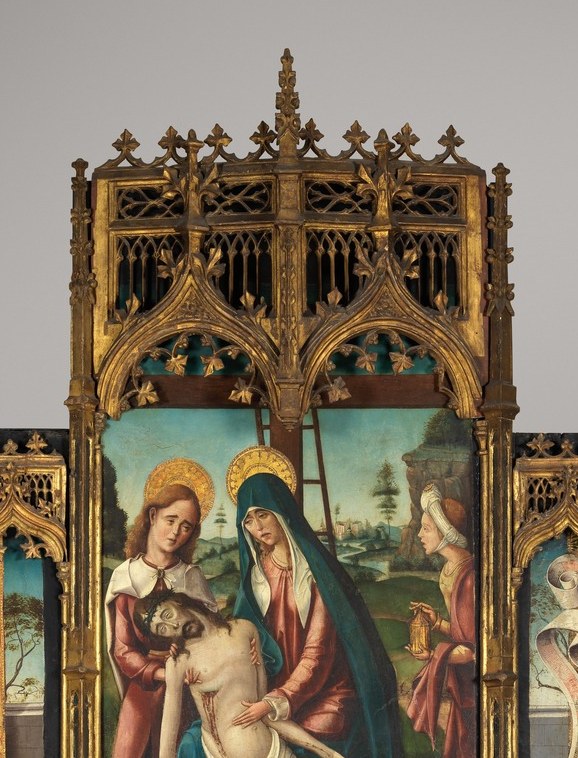 The theological summit of the altarpiece , the Virgin's grief and Christ's limp body form the devotional core that the surrounding saints orbit.