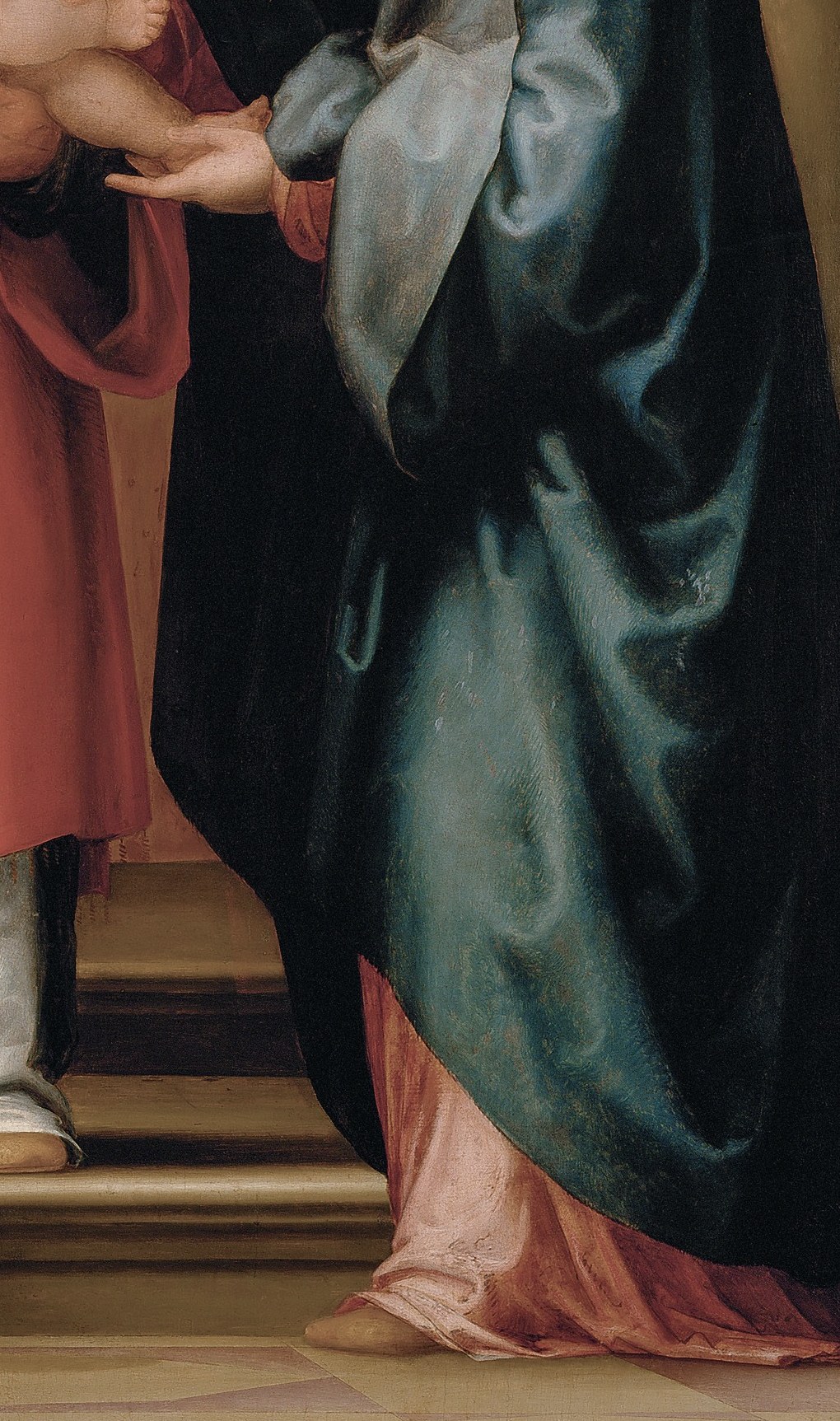 Her posture and outstretched hands suggest a tender, maternal acceptance of the child.