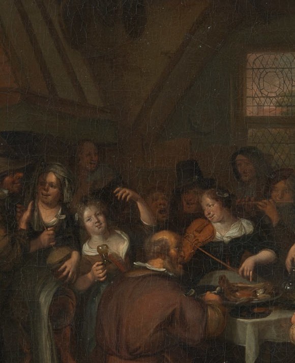 A boy plays a rommelpot: a pig-bladder drum rubbed to squeal.