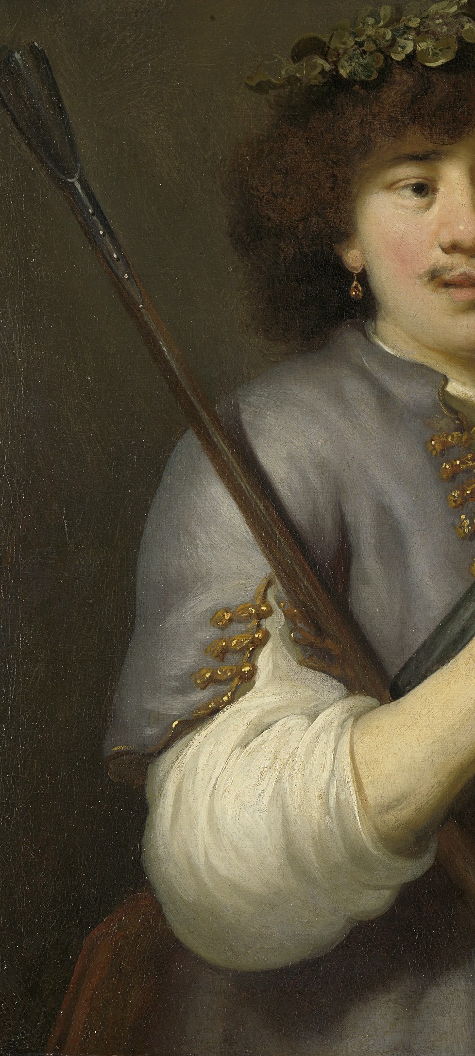 The long staff, resting on his shoulder, anchors the figure and emphasizes his pastoral role.