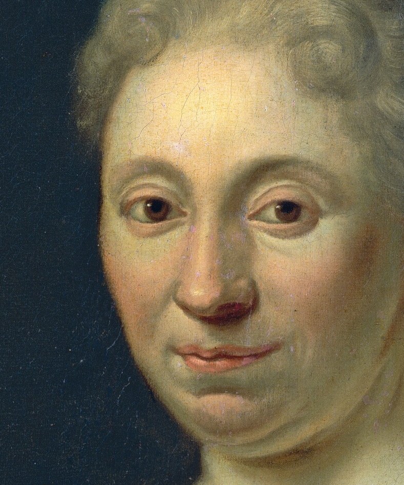 Her direct gaze and slight smile create an engaging and somewhat enigmatic presence.