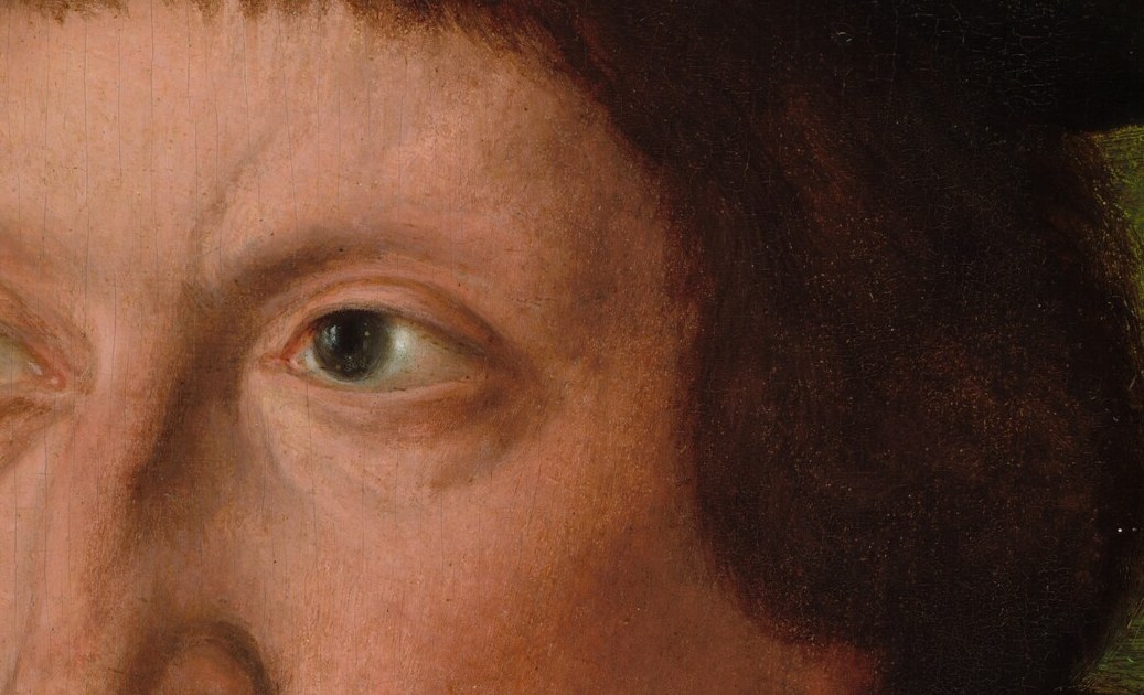 His eyes fix you with a watchful, almost wary gaze.