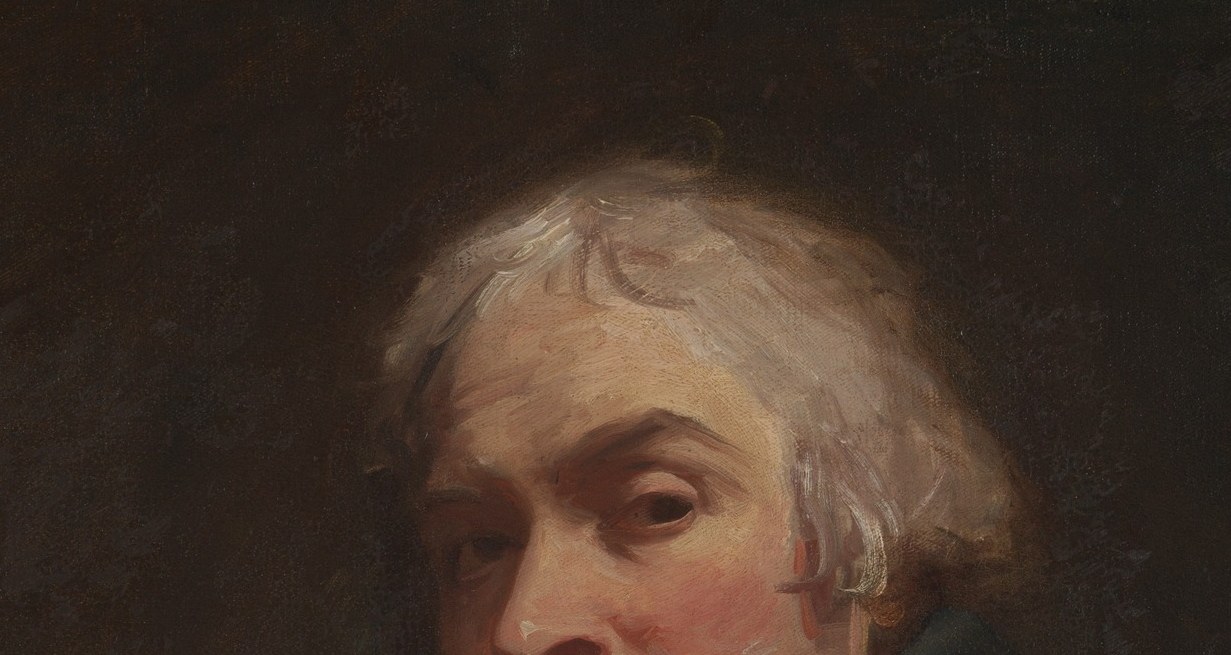 The natural, unkempt white hair resists fashionable portraiture conventions and signals an artist presenting himself without vanity.