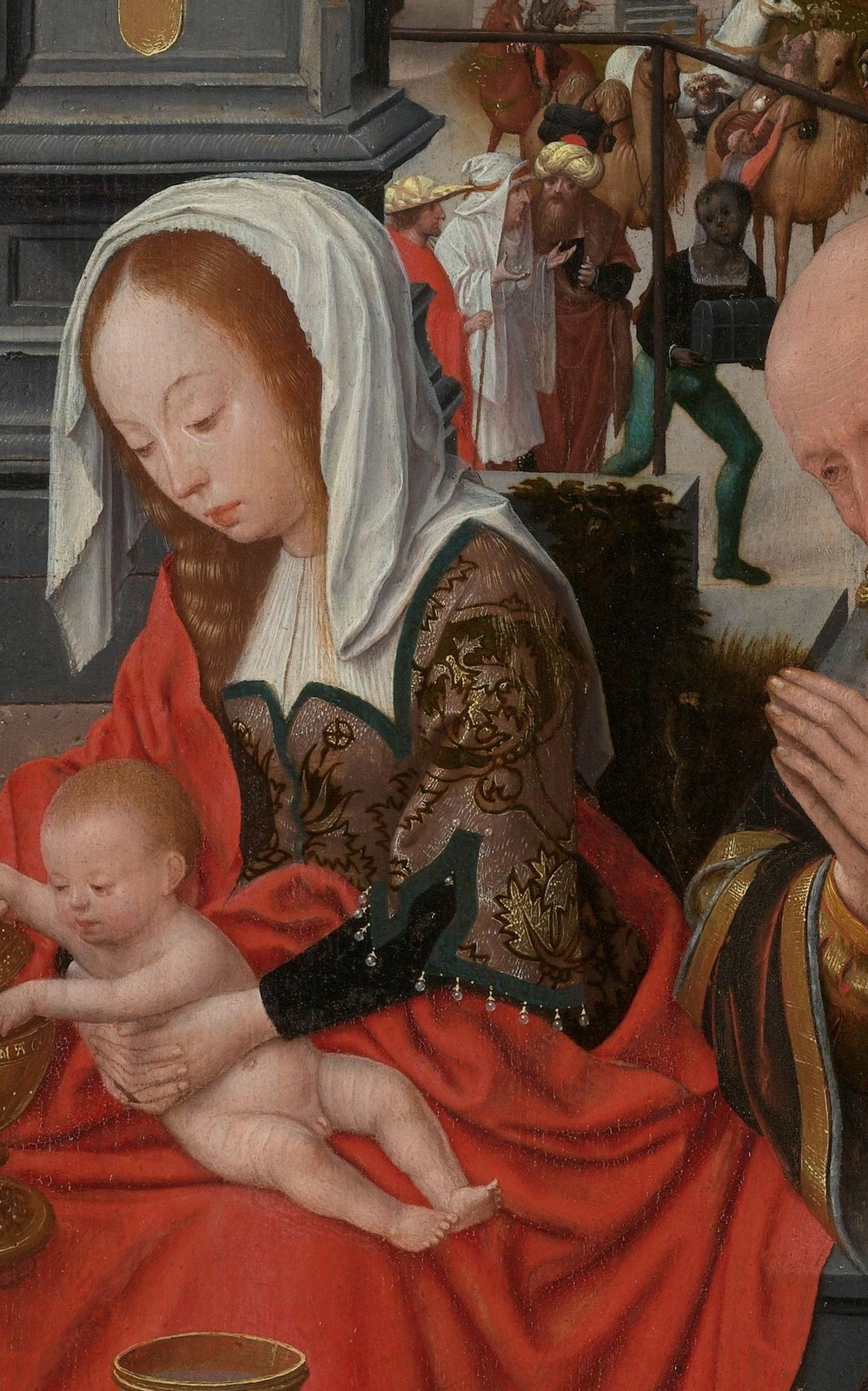 Her gentle gaze and posture convey maternal tenderness and quiet devotion.