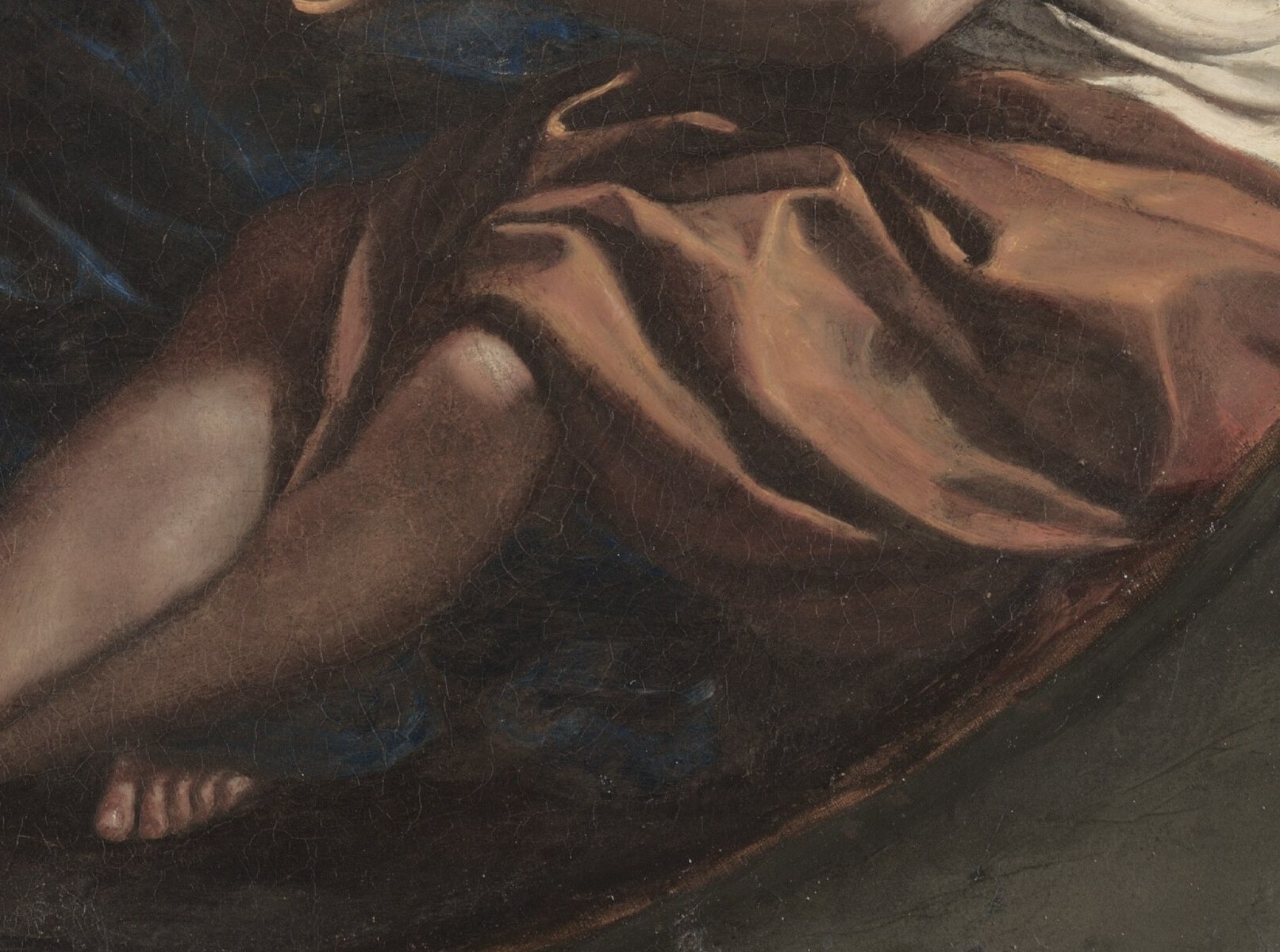 Mary looks weary. Her robe is dark blue.