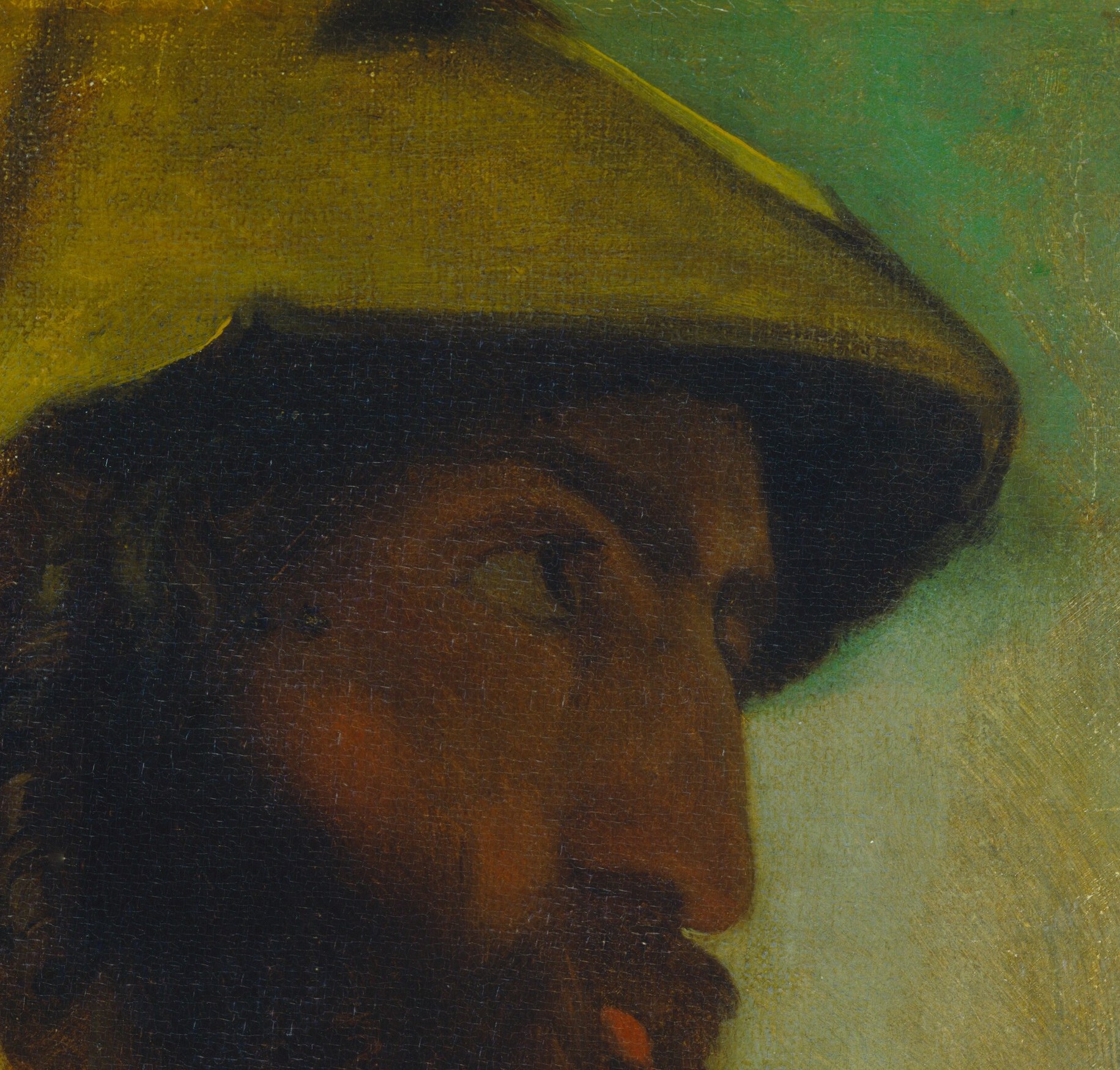 His wide-brimmed hat conceals his eyes from us.