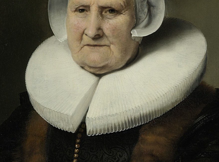The elaborate, crisp ruff emphasizes her social standing and the fashion of the era, creating a striking contrast with her face.