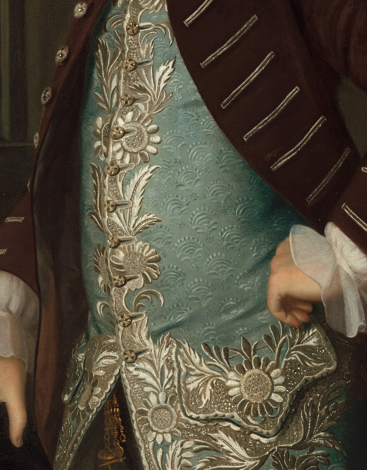 His expensive lace and embroidered silk waistcoat signal his status.