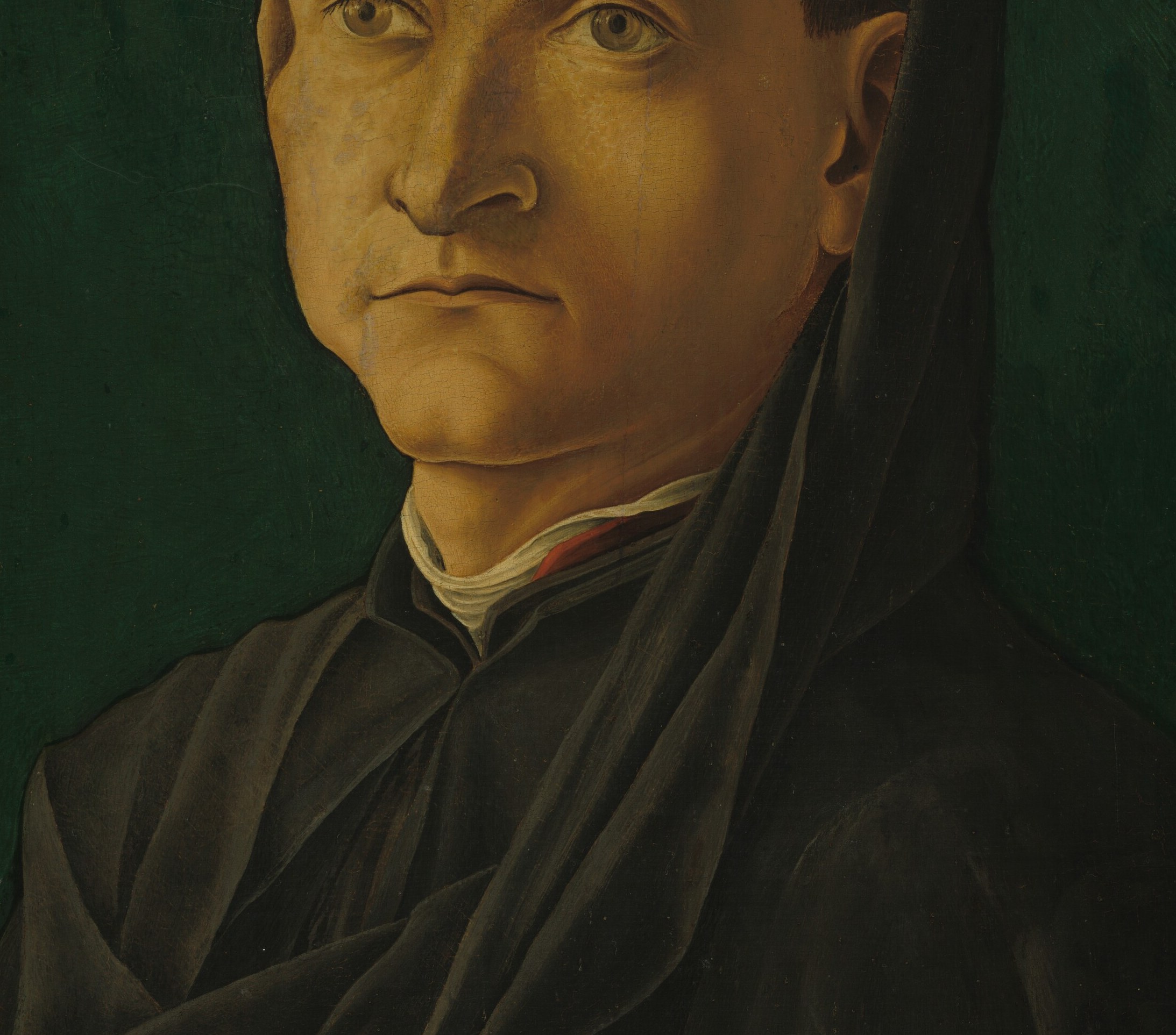 The broad, dark coat dominates the lower canvas; the painter uses it as a near-flat field, making the pale face and white collar luminous by contrast , a deliberate technique.