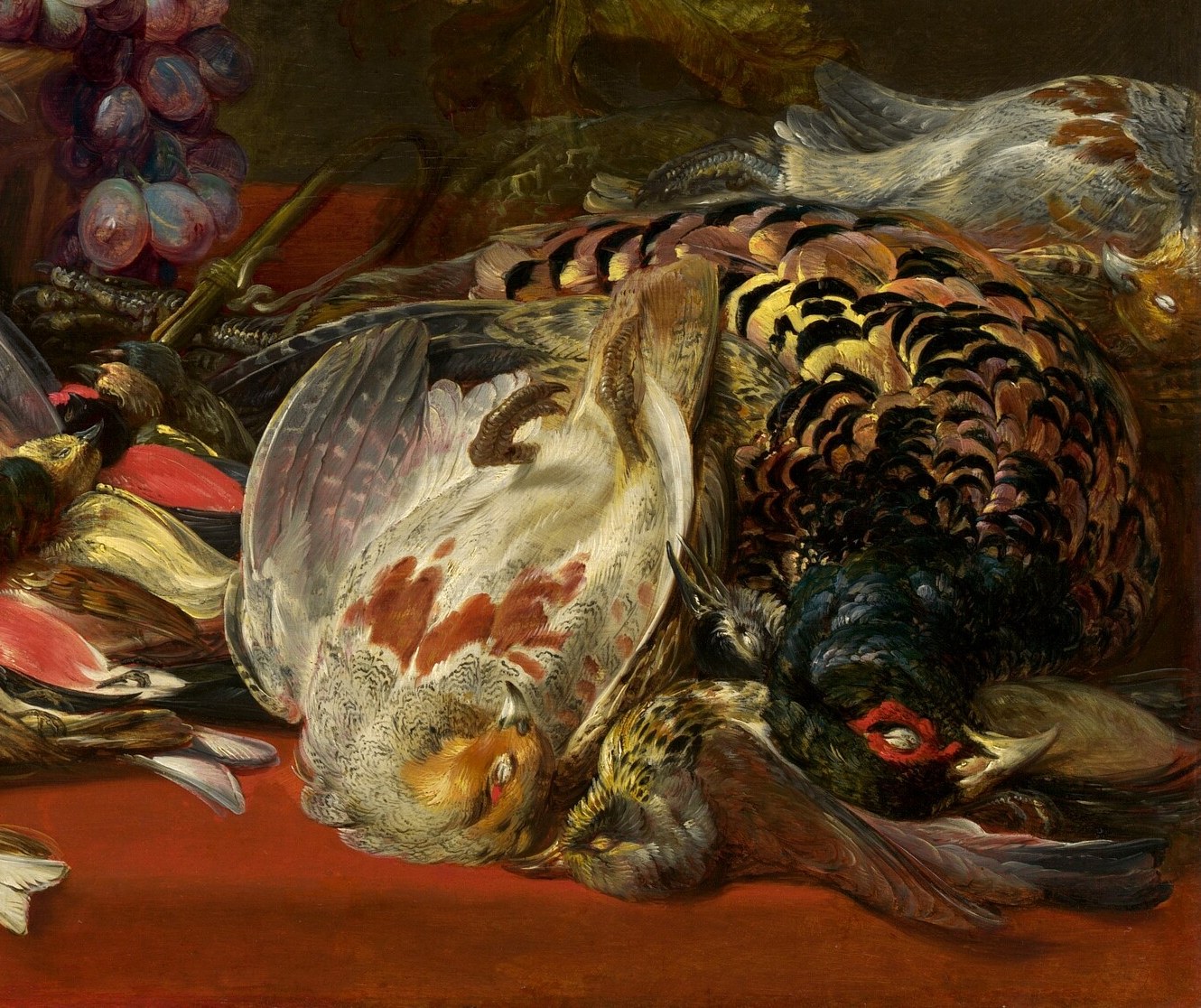 A pheasant and game birds spill from a hunt.