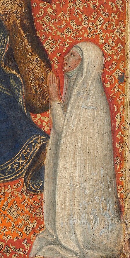 She kneels in prayer as the patron.