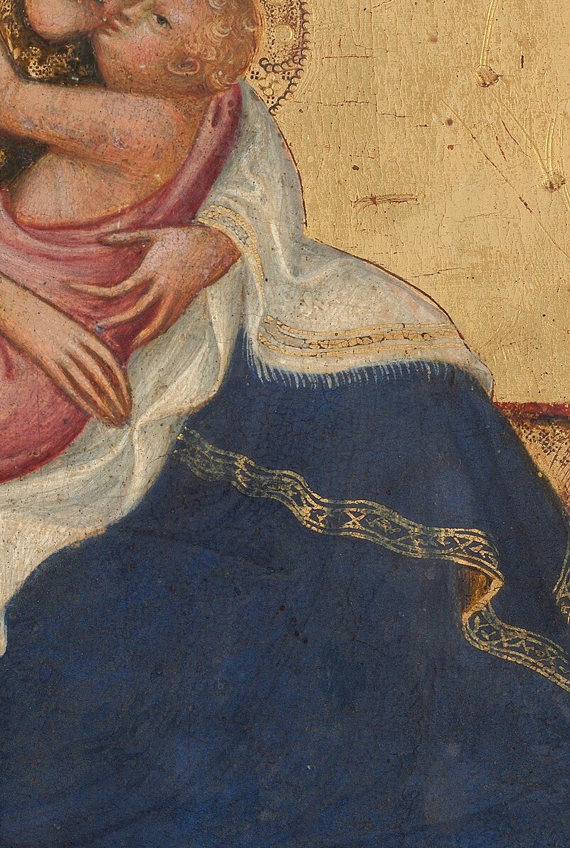 Her gilded robe signifies her wealth.