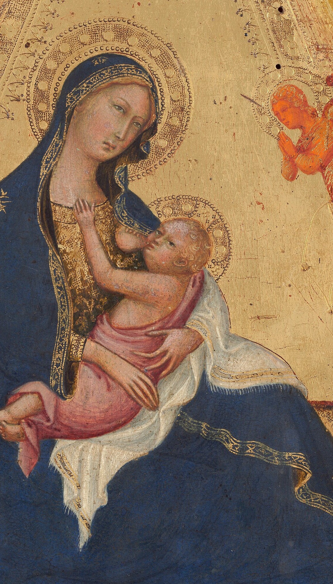 She sits in humility, holding her child.
