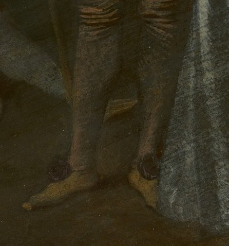 Look at the man's striped trousers.