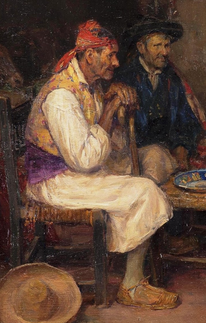 Four men in regional attire share a drink and conversation.