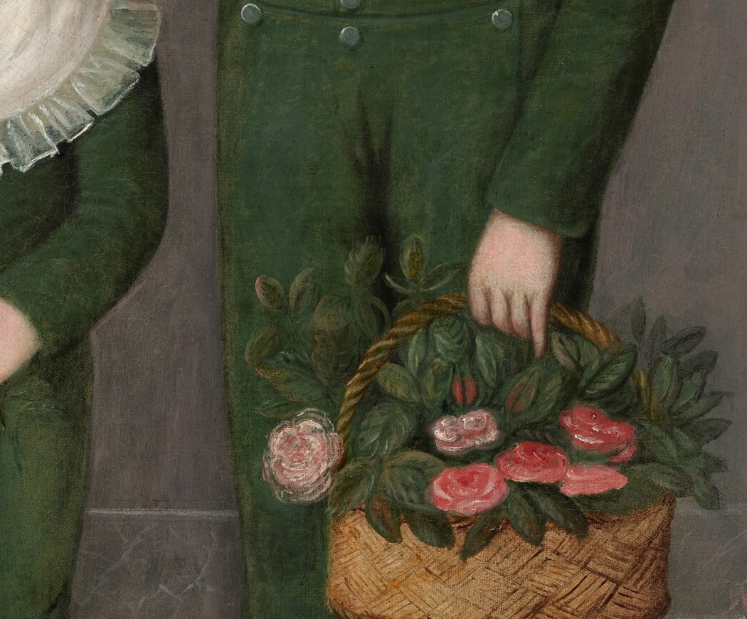 The youngest child holds a spray of pink roses.
