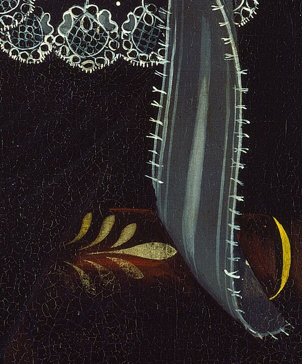 A small bee is perched near her wrist.