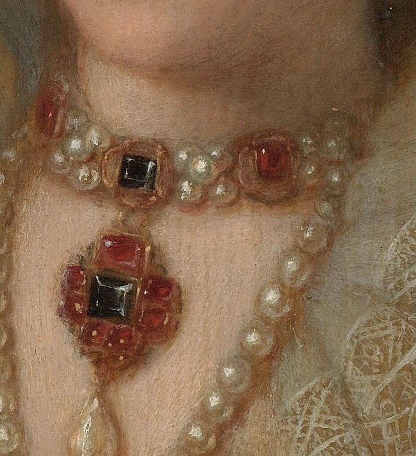 Pearls upon pearls. A large ruby at the center.