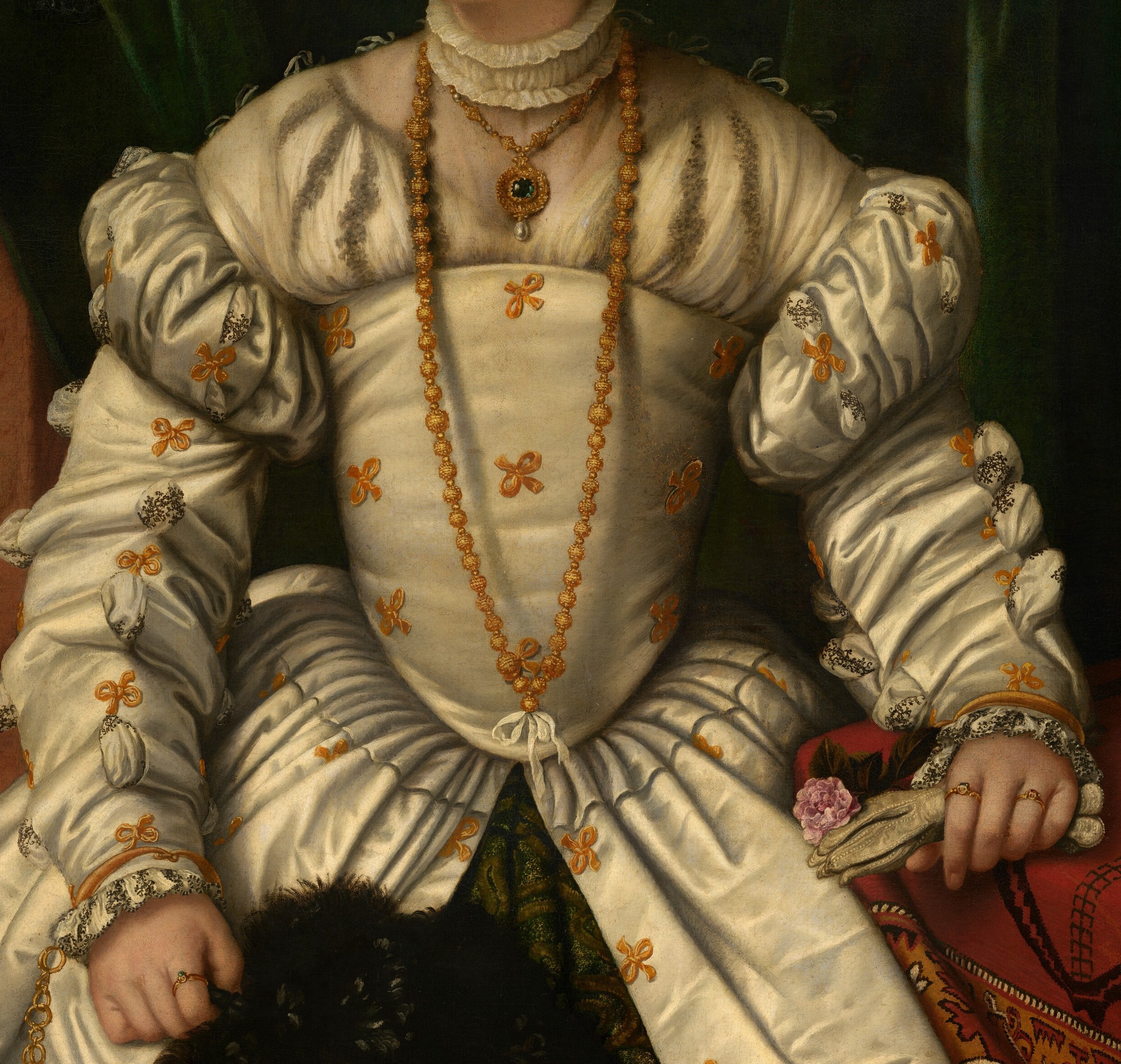 Her elaborate white gown is a symbol of opulence.