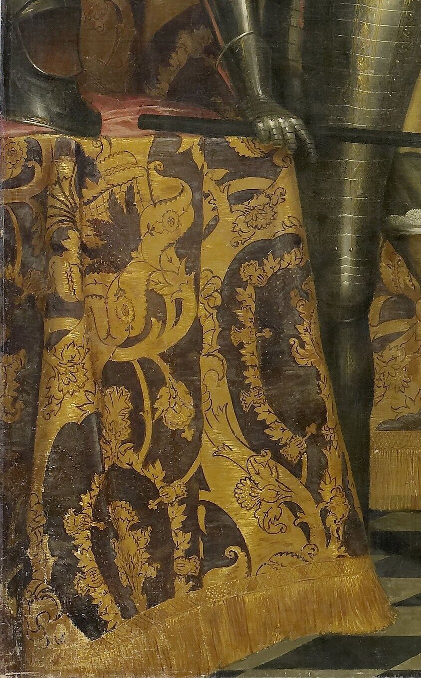 Look closely at the ornate tapestry behind her.
