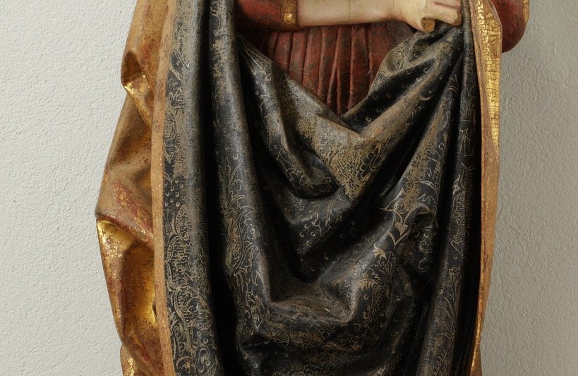 Her hands protect a book. It is her only earthly possession.