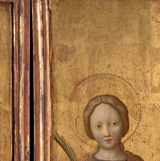A young woman holds a lamb and looks past us.