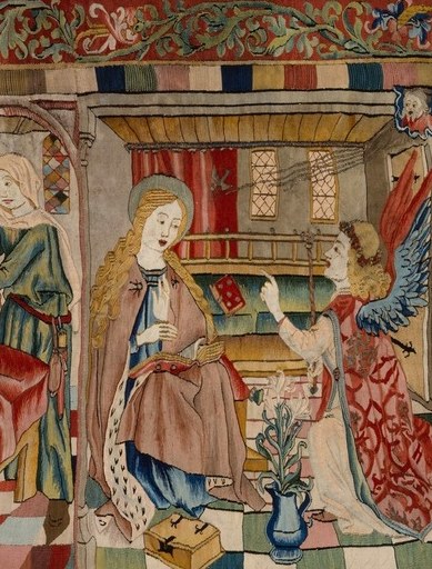 Large spread wings rendered in contrasting thread colors; the posture of address , body angled toward Mary , conveys the moment of divine interruption before Mary has responded.