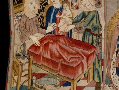 Likely St. Anne after giving birth to the Virgin; the bed scene anchors the opening of the life-cycle narrative and shows intimate domestic tenderness rare in monumental tapestry.